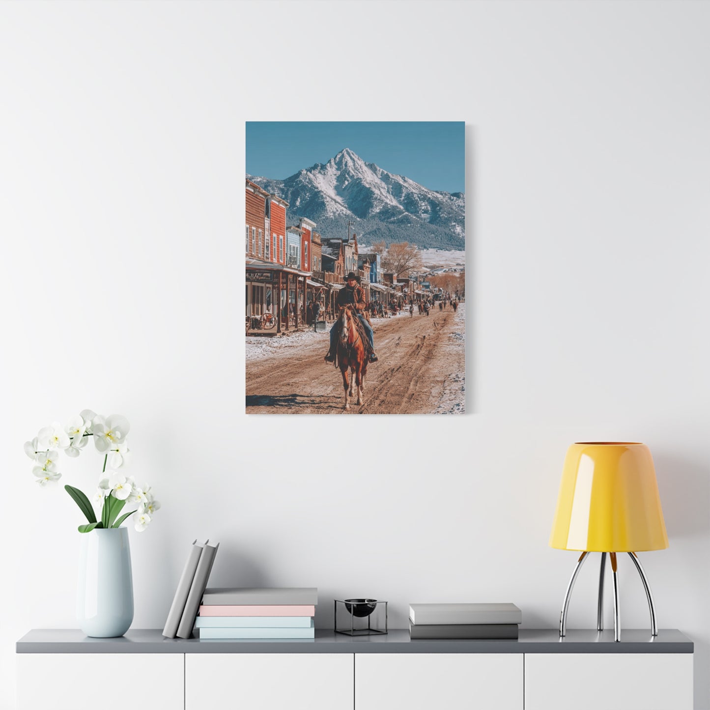 Cowboy Riding Through a Frontier Mountain Town Wall Art & Canvas Print