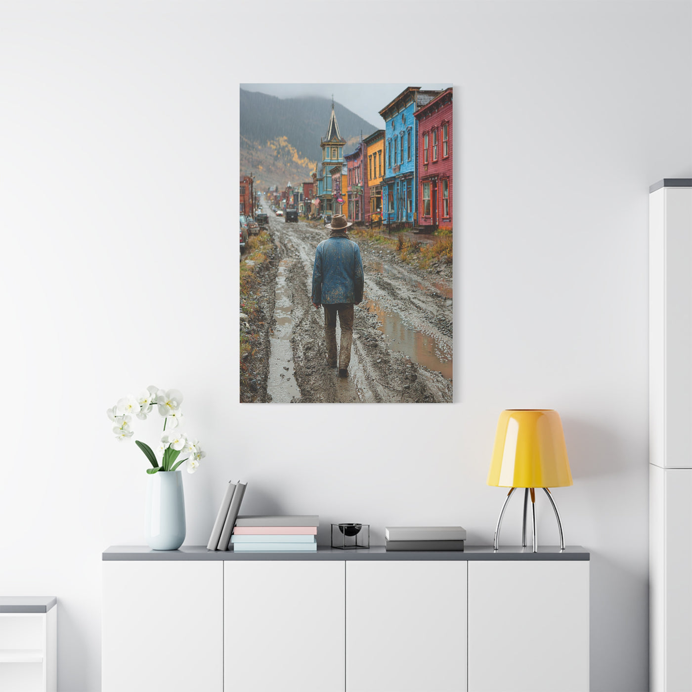 Lone Cowboy Walking Through a Rainy Frontier Street Wall Art & Canvas Print